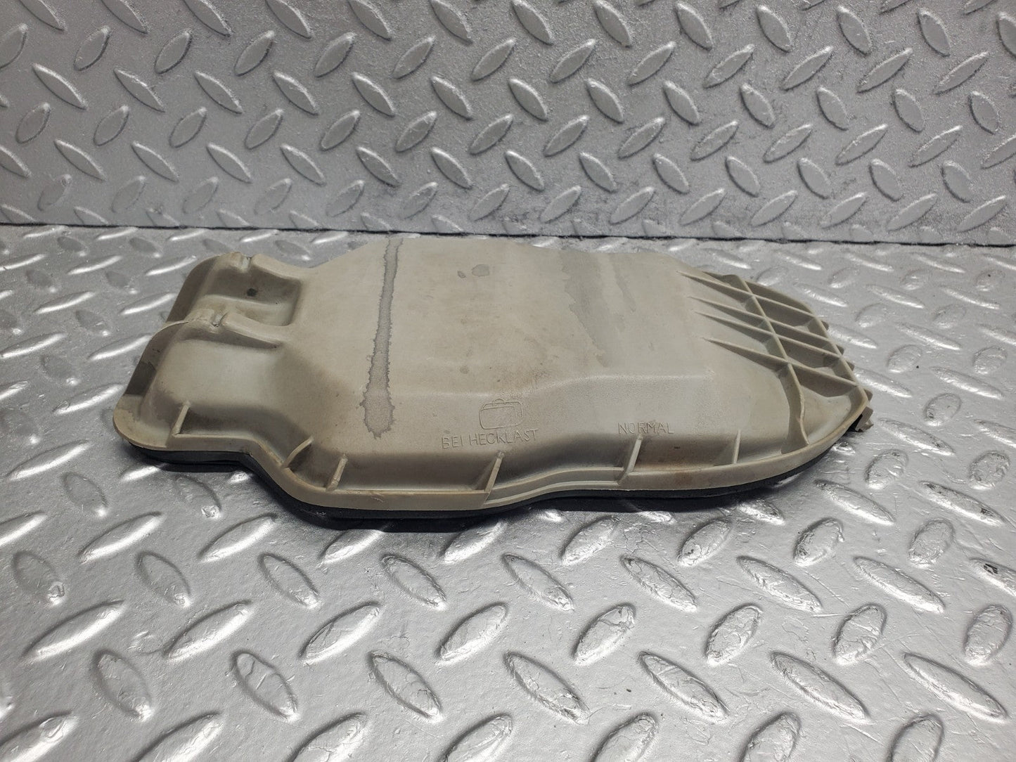 W123 headlight bulb cover left side used OEM
