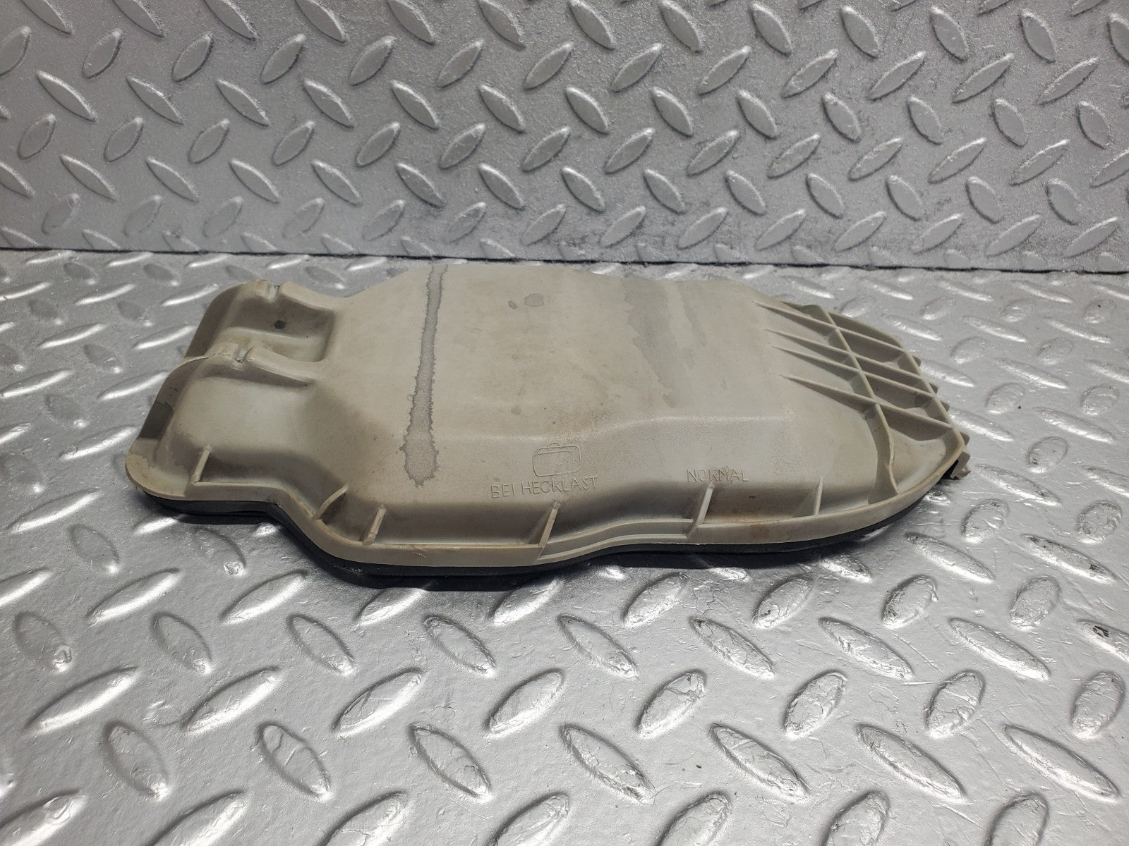 W123 headlight bulb cover left side used OEM